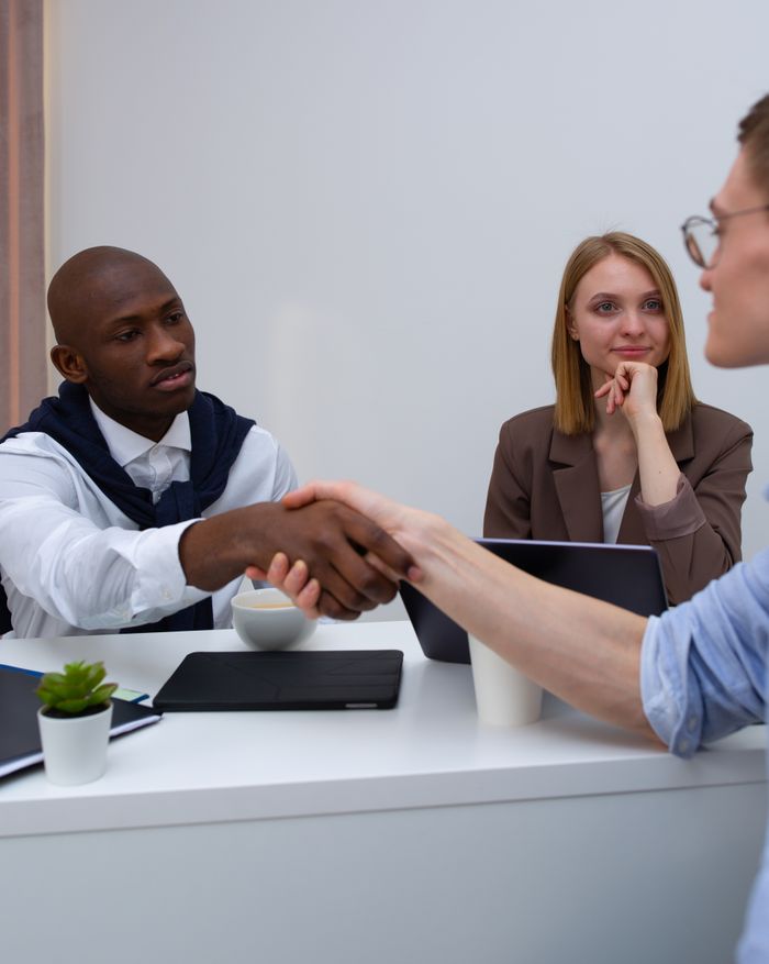 A diverse team in a professional meeting, symbolizing partnership and collaboration.